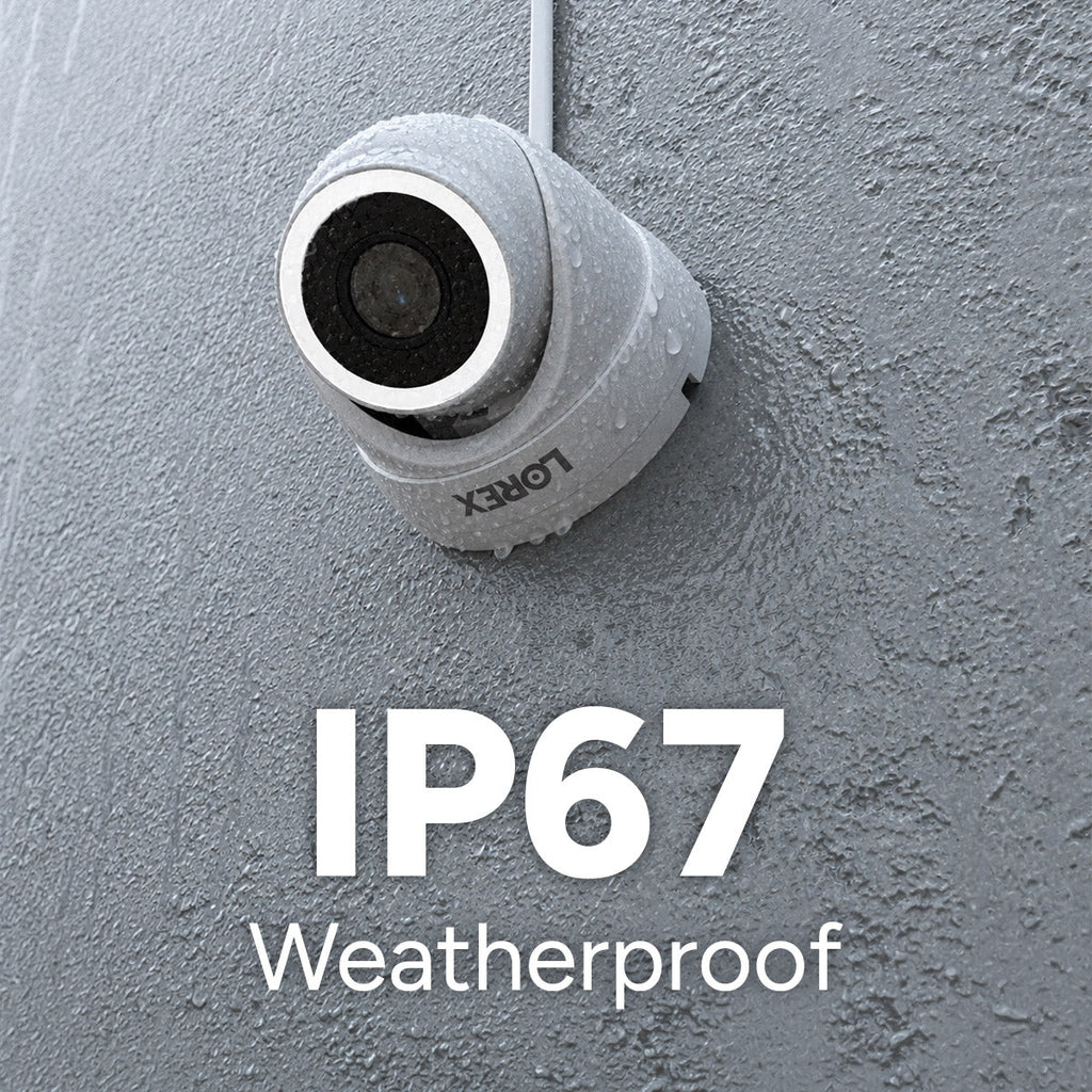 Close up of a weatherproof Lorex camera on a gray wall with water droplets and IP67 Weatherproof label