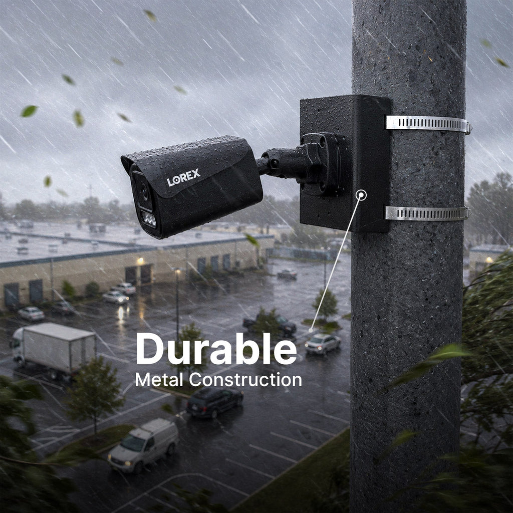 Outdoor security camera on a rain soaked pole secured with metal bands highlighting durable metal construction.