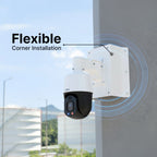 PTZ security camera mounted on a white corner bracket attached to an outdoor wall with a city skyline in the background