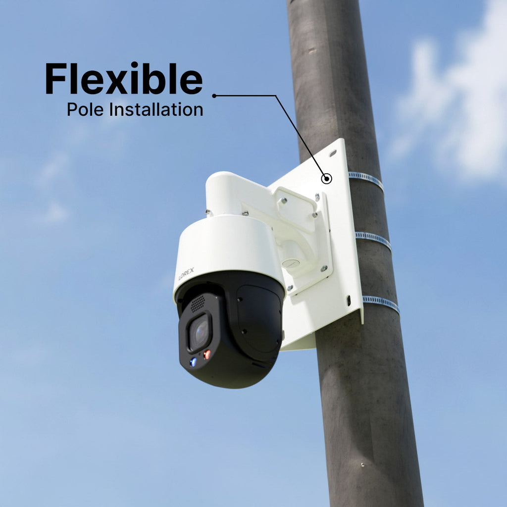 PTZ security camera mounted on a white pole bracket secured with straps against a blue sky