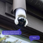 Outdoor Lorex Connect 2K Wi-Fi smart lightbulb pan tilt camera mounted under a wooden eave