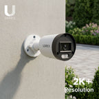 Lorex U Series outdoor security camera mounted to a beige wall with a 2K+ resolution badge