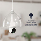 Pendant light fixture with a white security camera module mounted beneath the bulb socket